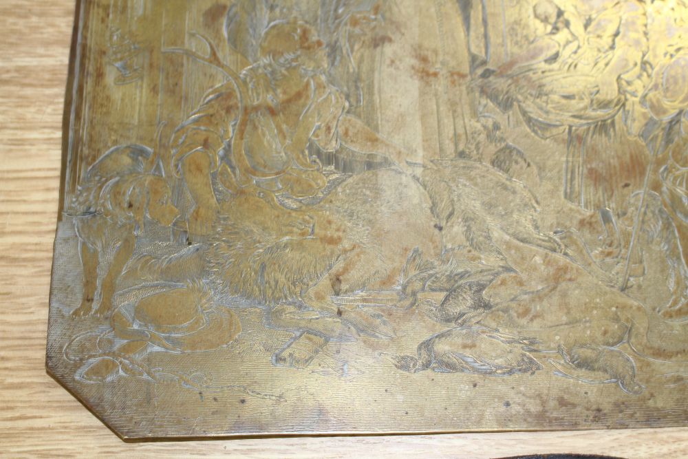 A 19th century engraved copper printing plate, probably later gilded, depicting figures around a stag